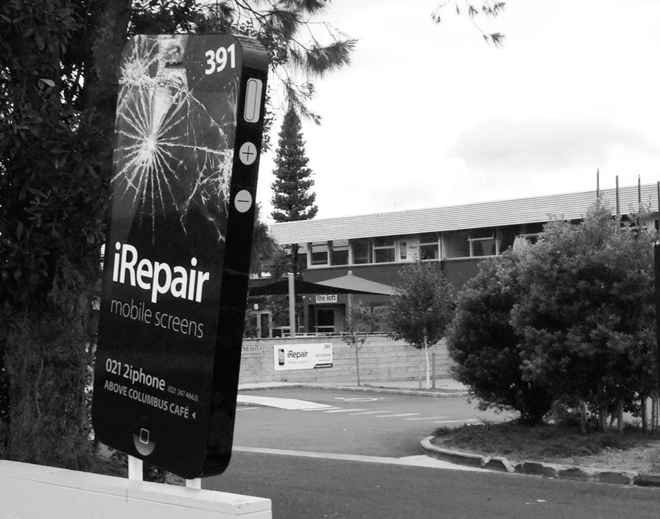 iRepair ‘mobile screens’ sign at 391 Rosebank Road, Avondale — above Columbus Coffee